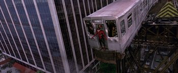 Movie still from “Spider-Man 2” (2004), directed by Sam Raimi – A man dressed as spider - man standing on the side of a train; Extreme Wide shot, High angle