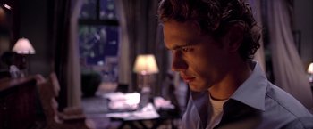 Movie still from “Spider-Man 2” (2004), directed by Sam Raimi – A young man is looking into the distance in the dark; Close Up shot, Low angle