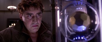 Movie still from “Spider-Man 2” (2004), directed by Sam Raimi – A man looking into a mirror in a dark room; Close Up shot, Low angle