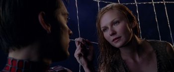 Movie still from “Spider-Man 2” (2004), directed by Sam Raimi – A man and a woman looking at each other through a net; Close Up shot, Low angle