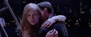 Movie still from “Spider-Man 2” (2004), directed by Sam Raimi – A man and a woman embracing each other in the dark; Close Up shot, Over the shoulder angle