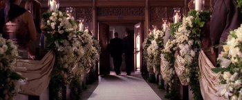 Movie still from “Spider-Man 2” (2004), directed by Sam Raimi – Two men walking down the aisle of a church; Wide shot, High angle