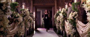 Movie still from “Spider-Man 2” (2004), directed by Sam Raimi – A woman in a black dress walking down the aisle of a wedding; Wide shot, High angle