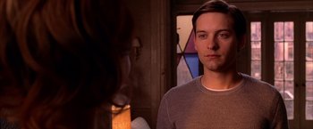 Movie still from “Spider-Man 2” (2004), directed by Sam Raimi – A man and a woman are standing in front of a stained glass window; Close Up shot, Over the shoulder angle