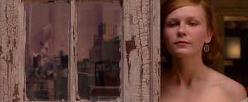 Movie still from “Spider-Man 2” (2004), directed by Sam Raimi – A woman standing in front of an old window; Close Up shot, Low angle