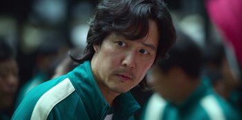 Movie still from “Squid Game” (2021), created by Hwang Dong-hyuk – A person with long hair; Close Up shot, Low angle