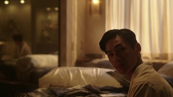 Movie still from “Mr. Robot” (2015), created by Sam Esmail – A man sitting on a bed in front of a window; Medium shot, Over the shoulder angle