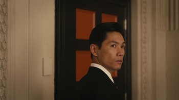 Movie still from “Mr. Robot” (2015), created by Sam Esmail – A person wearing a suit near a door; Close Up shot, Low angle