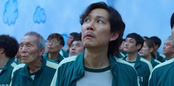 Movie still from “Squid Game” (2021), created by Hwang Dong-hyuk – A group of men standing next to each other; Close Up shot, Low angle