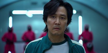 Movie still from “Squid Game” (2021), created by Hwang Dong-hyuk – A person wearing a jacket; Close Up shot, Low angle