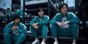 Movie still from “Squid Game” (2021), created by Hwang Dong-hyuk – A group of men sitting next to each other on a bench; Medium shot, Low angle