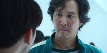 Movie still from “Squid Game” (2021), created by Hwang Dong-hyuk – A person talking to another person; Close Up shot, Over the shoulder angle