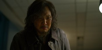 Movie still from “Squid Game” (2021), created by Hwang Dong-hyuk – A person with long hair; Close Up shot, Low angle