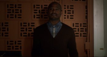 Movie still from “Still Alice” (2014), directed by Richard Glatzer – A man standing in front of a wall; Medium shot, Low angle