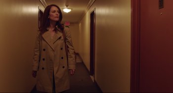 Movie still from “Still Alice” (2014), directed by Richard Glatzer – A woman wearing a trench coat walking down a hallway; Medium shot, Low angle