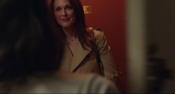 Movie still from “Still Alice” (2014), directed by Richard Glatzer – A woman in a trench coat smiling for the camera; Close Up shot, Over the shoulder angle