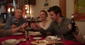 Movie still from “Still Alice” (2014), directed by Richard Glatzer – A group of people sitting at a dinner table drinking red wine; Medium shot, High angle