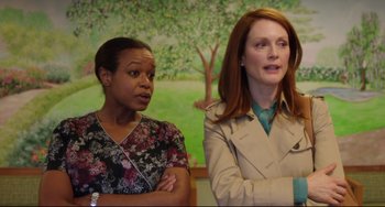 Movie still from “Still Alice” (2014), directed by Richard Glatzer – Two women standing next to each other in front of a painting; Medium shot, Over the shoulder angle
