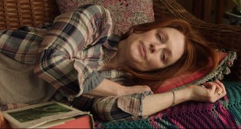 Movie still from “Still Alice” (2014), directed by Richard Glatzer – A woman laying on the ground with her head on a book; Medium shot, High angle