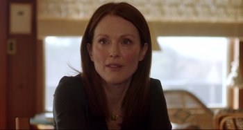 Movie still from “Still Alice” (2014), directed by Richard Glatzer – Julianna margulies in a black shirt and necklace; Close Up shot, Over the shoulder angle