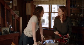 Movie still from “Still Alice” (2014), directed by Richard Glatzer – Two women standing at a table in front of a plate of food; Medium shot, Over the shoulder angle