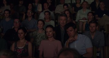 Movie still from “Still Alice” (2014), directed by Richard Glatzer – A group of people sitting in a room watching a show; Medium shot, High angle