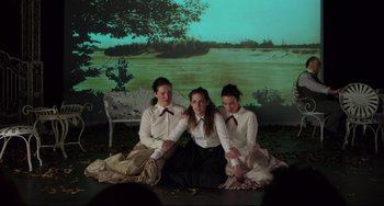 Movie still from “Still Alice” (2014), directed by Richard Glatzer – A group of three young women sitting next to each other on the ground; Medium shot, High angle