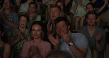 Movie still from “Still Alice” (2014), directed by Richard Glatzer – A group of people sitting in a room clapping; Medium shot, Over the shoulder angle