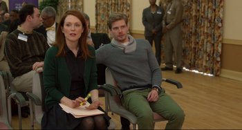 Movie still from “Still Alice” (2014), directed by Richard Glatzer – A woman and a man sitting in a chair; Medium shot, Over the shoulder angle