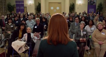 Movie still from “Still Alice” (2014), directed by Richard Glatzer – A group of people sitting in front of a woman; Wide shot, Over the shoulder angle