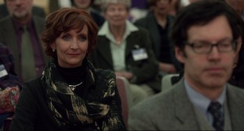 Movie still from “Still Alice” (2014), directed by Richard Glatzer – A group of people sitting in front of each other in a room; Close Up shot, Over the shoulder angle