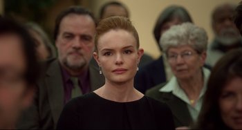 Movie still from “Still Alice” (2014), directed by Richard Glatzer – A group of people standing around a woman in a black dress; Close Up shot, Over the shoulder angle