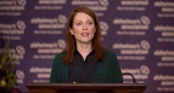 Movie still from “Still Alice” (2014), directed by Richard Glatzer – Julianne moore speaking at a press conference; Medium shot, Low angle