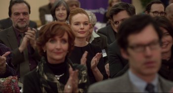 Movie still from “Still Alice” (2014), directed by Richard Glatzer – A group of people sitting in a room clapping; Close Up shot, Over the shoulder angle