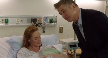 Movie still from “Still Alice” (2014), directed by Richard Glatzer – A man and a woman in a hospital room with a baby; Medium shot, Over the shoulder angle