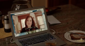 Movie still from “Still Alice” (2014), directed by Richard Glatzer – A laptop computer sitting on top of a wooden table; Medium shot, Over the shoulder angle
