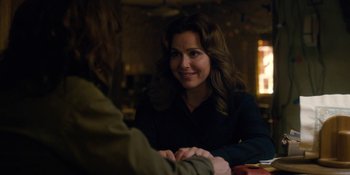 Movie still from “Stranger Things” (2016), created by Ross Duffer – A woman sitting at a table with another woman; Close Up shot, Over the shoulder angle