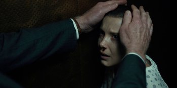 Movie still from “Stranger Things” (2016), created by Ross Duffer – A man touching the head of a young woman; Close Up shot, Over the shoulder angle