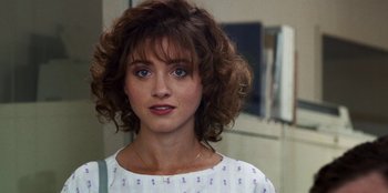 Movie still from “Stranger Things” (2016), created by Ross Duffer – A person wearing a white shirt; Close Up shot, Over the shoulder angle