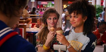 Movie still from “Stranger Things” (2016), created by Ross Duffer – Two young women eating ice - cream at a restaurant; Close Up shot, Over the shoulder angle