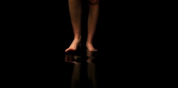 Movie still from “Stranger Things” (2016), created by Ross Duffer – A person standing in the middle of a dark room; Extreme Close Up shot, Low angle