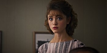 Movie still from “Stranger Things” (2016), created by Ross Duffer – A person wearing a dress; Close Up shot, Over the shoulder angle