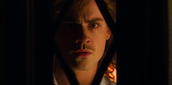 Movie still from “Stranger Things” (2016), created by Ross Duffer – A person with a beard and mustache; Close Up shot, Low angle