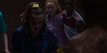Movie still from “Stranger Things” (2016), created by Ross Duffer – A group of people standing in a room; Close Up shot, Over the shoulder angle