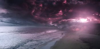 Movie still from “Stranger Things” (2016), created by Ross Duffer – A purple sky with dark clouds over the ocean; Extreme Wide shot, High angle