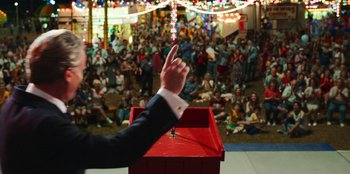 Movie still from “Stranger Things” (2016), created by Ross Duffer – A man with his hand raised in the air; Medium shot, Low angle