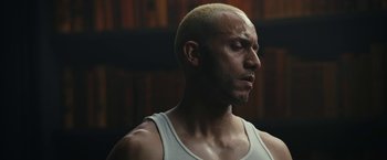 Movie still from “Mr. Robot” (2015), created by Sam Esmail – A man with a bald head is looking down; Close Up shot, Low angle