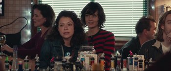 Movie still from “Stronger” (2017), directed by David Gordon Green – Two women are sitting at a table in front of a window; Medium shot, Over the shoulder angle