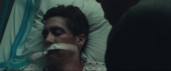 Movie still from “Stronger” (2017), directed by David Gordon Green – A man in a hospital bed taped to his mouth; Close Up shot, Over the shoulder angle