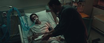 Movie still from “Stronger” (2017), directed by David Gordon Green – A man in a hospital bed with an injured patient; Medium shot, High angle